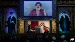 Hezbollah leader Hassan Nasrallah delivers a broadcast speech during a rally to commemorate the 40th anniversary of Iran's Islamic Revolution, in southern Beirut, Lebanon, Feb. 6, 2019. 
