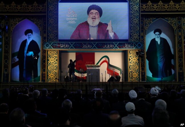 FILE - Hezbollah leader Hassan Nasrallah delivers a broadcast speech during a rally to commemorate the 40th anniversary of Iran's Islamic Revolution, in southern Beirut, Lebanon, Feb. 6, 2019.