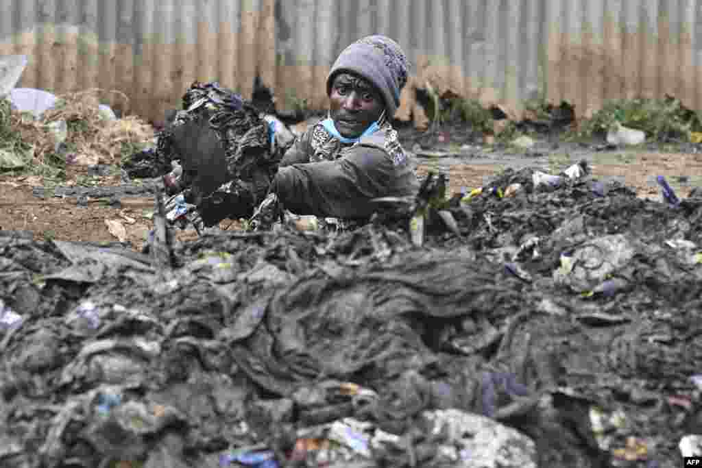 A Kenyan environment activist unclogs drainage ahead of World Environmental Day celebrations in Riruta, Nairobi.