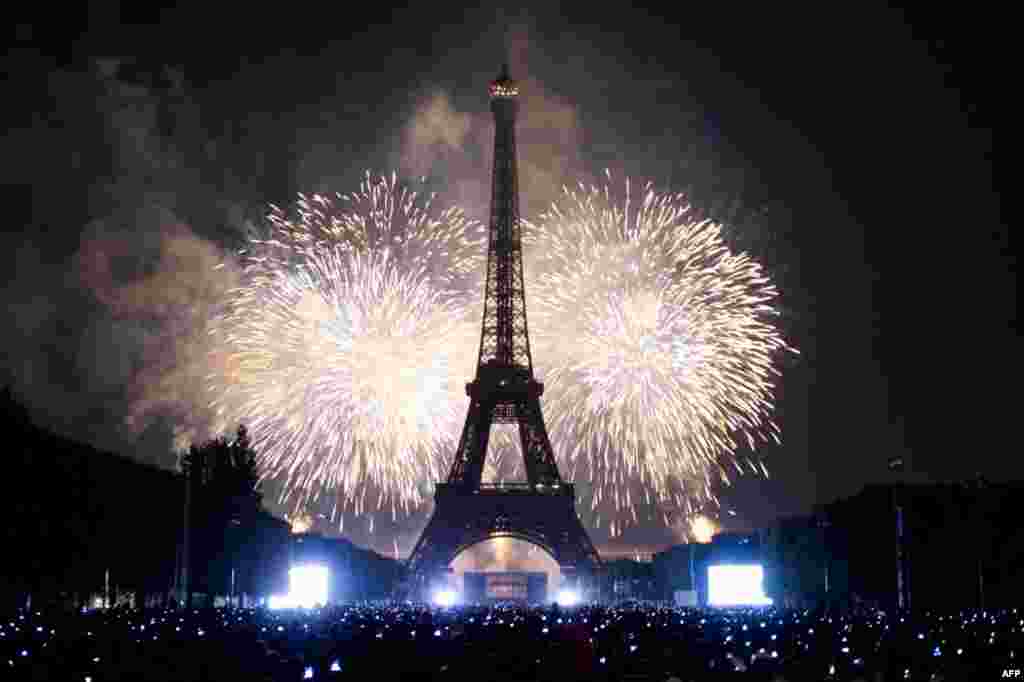 July 14: The Eiffel Tower is illuminated during the traditional Bastille Day fireworks display in Paris.REUTERS/Gonzalo Fuentes