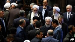 Iran's President Hasan Rouhani, center, leaves the parliament at the end of his swearing-in ceremony for the second term in office, in Tehran, Iran, Aug. 5, 2017.