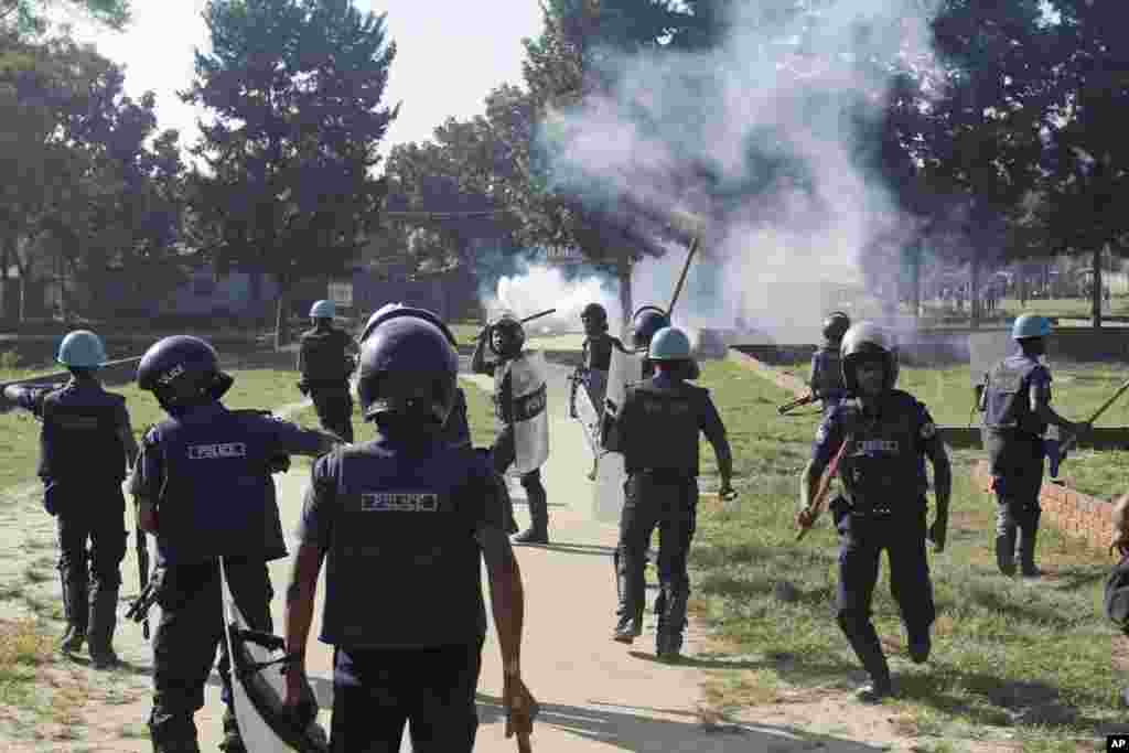 Riot police chase garment workers during their clash in Ashulia on the outskirts of Dhaka, Bangladesh, Nov. 12, 2013. 