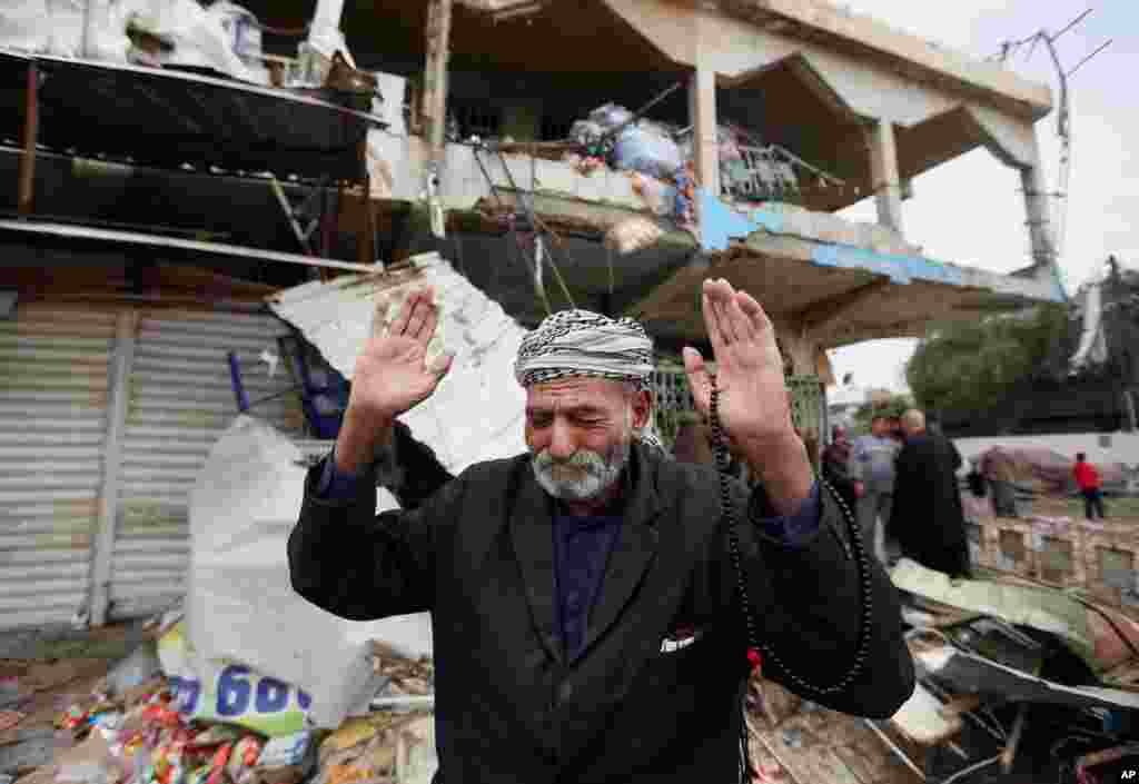 An Iraqi man reacts at the site of a car bomb explosion in the Shaab neighborhood of Baghdad, Iraq.