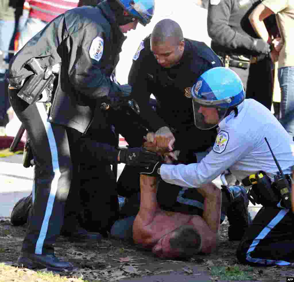 An unidentified protestor is arrested in McPherson Square in downtown Washington Sunday, Dec. 4, 2011. U.S. Park Police are arresting Occupy DC protesters who are refusing to dismantle an unfinished wooden structure erected in the park square overnight. (