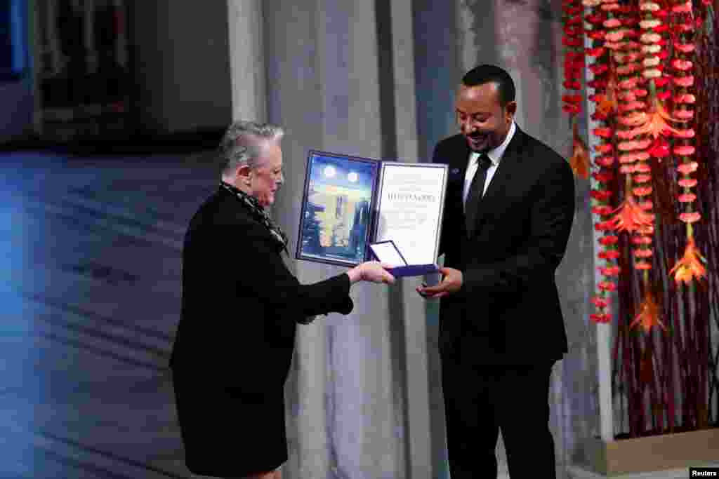 Ethiopian Prime Minister Abiy Ahmed Ali receives a medal and award from Chair of the Nobel Committee Berit Reiss-Andersen during the Nobel Peace Prize ceremony in Oslo, Norway.