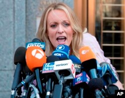 FILE - Adult film actress Stormy Daniels addresses reporters outside federal court in New York, April 16, 2018.