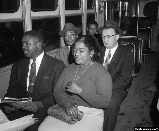 FILE - Two Black ministers were among the first to ride after the Supreme Court's integration order went into effect, Dec. 21, 1956. At left, front seat, is the Rev. Ralph Abernathy, while at left in the second seat is the Rev. Dr. Martin Luther King, Jr.