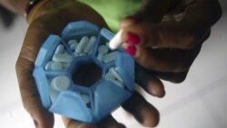 A patient infected with HIV prepares her medicines in this 2008 file photo
