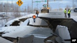 Workers inspect an off-ramp that collapsed during a morning earthquake, Nov. 30, 2018, in Anchorage, Alaska.