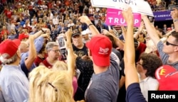 Trump supporters point out a protester to be removed during U.S. President Donald Trump's "Make America Great Again" rally in Evansville, Indiana, Aug. 30, 2018.