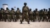 FILE - Mozambican soldiers stand as Mozambican President Filipe Nyusi and Rwanda President Paul Kagame review the troops on Sept. 24, 2021, in Pemba, Cabo Delgado province, Mozambique.