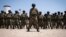 FILE - Mozambican soldiers stand as Mozambican President Filipe Nyusi and Rwanda President Paul Kagame review the troops on Sept. 24, 2021, in Pemba, Cabo Delgado province, Mozambique.