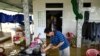 Phan Gia Quang makes tea at his flooded house in Quang Dien district in central Vietnam&#39;s Hue province.