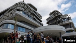 Visitors watch celebrations of Indonesia's 79th Independence Day from office buildings under construction near the Presidential Palace, in the planned new capital of Nusantara on Aug. 17, 2024.