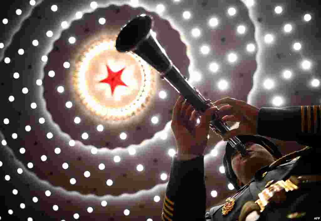 A musician plays his instrument during the ceremony to commemorate the 70th anniversary of China’s entry into the 1950-53 Korean War, at the Great Hall of the People in Beijing. (AFP)