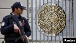 A police officer stands guard in front of the German Consulate, which is closed on indications of a possible imminent attack, in Istanbul, Turkey, March 17, 2016.