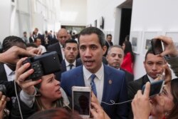 FILE - Venezuelan opposition leader Juan Guaido speaks to journalists during a regional counterterrorism meeting at the police academy in Bogota, Colombia, Jan. 20, 2020.