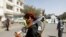 FILE - A Houthi supporter carries a weapon during a gathering in Sanaa, Yemen, April 2, 2020.