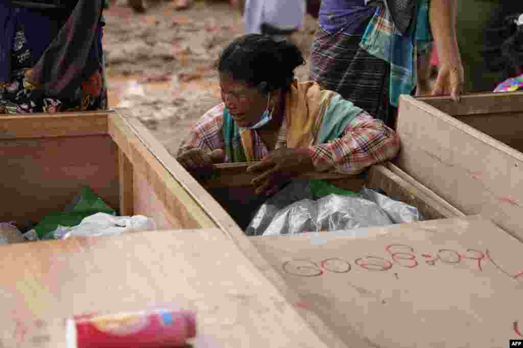 A woman grieves over a body of a miner during a funeral ceremony near Hpakant in Kachin state, Myanmar.