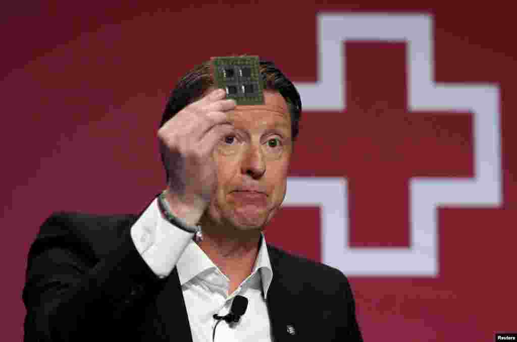 Ericsson's President & CEO Hans Vestberg shows a 5G chip as he delivers a keynote speech during the Mobile World Congress in Barcelona, Spain, Feb. 22, 2016.