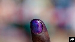 A Sudanese voter shows the purple ink on his index finger after casting his vote in the week-long independence referendum expected to lead to the partition of Africa's largest nation, 09 Jan 2011