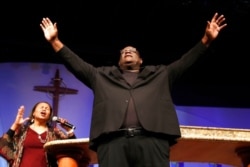 FILE - Dwight McKissic, pastor of Cornerstone Baptist Church, and his wife, Vera McKissic, pray during services in Arlington, Texas, June 7, 2020.