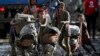 Children push baby strollers full of belongings they retrieved from their homes damaged by Typhoon Vamco in Rodriguez, Rizal province, Philippines.