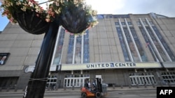 A worker delivers metal barriers outside the United Center ahead of the Democratic National Convention (DNC) in Chicago, Illinois on August 17, 2024.