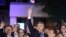Andrej Plenkovic, Croatia's incumbent prime minister, center, waves a Croatian flag as he celebrates with his HDZ party members, in Zagreb, Croatia, July 5, 2020.