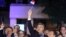Andrej Plenkovic, Croatia's incumbent prime minister, center, waves a Croatian flag as he celebrates with his HDZ party members, in Zagreb, Croatia, July 5, 2020.