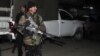 A policeman stands near the site of a rocket attack at Peshawar's airport in Pakistan, Dec. 15, 2012. 