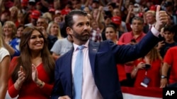FILE - Donald Trump Jr. and Kimberly Guilfoyle arrive for President Donald Trump's re-election kickoff rally at the Amway Center, June 18, 2019, in Orlando.