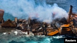 Smoke rises from a fire onboard the <em>MV X-Press Pearl</em> vessel as it sinks while being towed into deep sea off the Colombo Harbor in Sri Lanka. (Credit: Sri Lank Air Force)