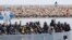 FILE - After more than 300 migrants died Friday trying to cross the Mediterranean, other migrants arrived by boat at the Sicilian harbor of Pozzallo, Italy, Feb.15, 2015. 