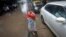 A boy sells roses while standing on a road divider during in Mumbai in this July 12, 2013, file photo.