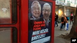 A phone box displays a billboards showing Hungarian-American financier George Soros and EU Commission President Jean-Claude Juncker above the caption “You have a right to know what Brussels is preparing to do!," on Vaci Avenue in Budapest, Hungary, Feb. 19, 2019.