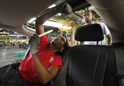 FILE - An assembly worker is pictured at the General Motors Hamtramck Assembly plant in Hamtramck, Michigan. GM said July 25, 2019, that it was still hoping for a nationwide deal on auto emissions standards.