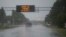 Cars drive on a wet road as rain from Hurricane Florence falls in Wilmington, North Carolina, Sept. 13, 2018. The huge storm weakened to a Category 1 hurricane overnight, but forecasters warned that it still packed dangerous winds and torrential rains.