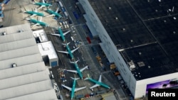 FILE - An aerial photo shows Boeing 737 Max airplanes parked on the tarmac at the Boeing factory in Renton, Wash., March 21, 2019.