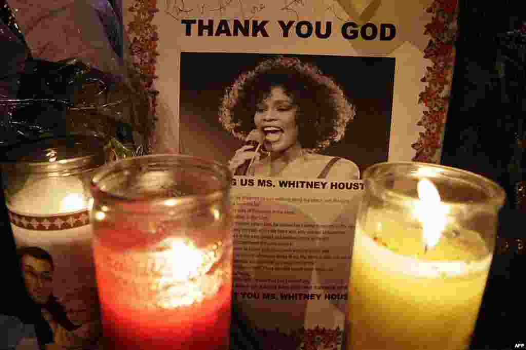 Candles burn at a memorial to Whitney Houston outside New Hope Baptist Church in Newark, N.J., early on February 18, 2012. The pop star sang in the church choir as a girl. (AP)