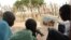 Isaiah Deng Mayom, right, Carter Center field officer, uses a flip chart to show children how to avoid contracting guinea worm, Lakes State, Sudan, Nov. 4, 2010.