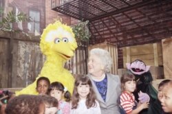 FILE - First lady Barbara Bush chats with Big Bird and several children while taping a special segment of PBS' "Sesame Street," Oct. 19, 1989.
