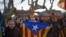 Pro-independence supporters holds "estelada" flags as they celebrate the results of a symbolic declaration of sovereignty in front of Catalonia's Parliament in Barcelona, Spain, Jan. 23, 2013. 