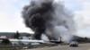 Smoke rises from a factory hit during clashes by Syrian security forces and gunmen loyal to ousted President Bashar al-Assad, on the outskirts of Latakia, Syria, March 7, 2025. 