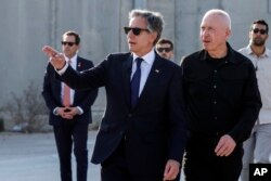 FILE—U.S. Secretary of State Antony Blinken walks with Israeli Defense Minister Yoav Gallant, right, at the Kerem Shalom border crossing in Kerem Shalom, Israel, May 1, 2024.