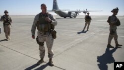 Out going U.S. Marine Brigadier Gen. Roger B. Turner walks on the airfield after the change of command ceremony in Shorab military camp of Helmand province, Afghanistan, Jan. 15, 2018. 