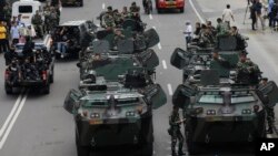 Indonesian soldiers man armored vehicles as they guard near the site where an attack occurred in Jakarta, Jan. 14, 2016.