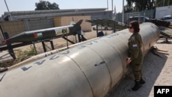 2024年4月16日，當媒體參觀以色列南部城市馬拉基市附近的朱利斯軍事基地時，一名以色列軍人站在一枚落在以色列的伊朗彈道飛彈旁。