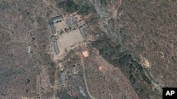 Satellite image provided by GeoEye appears to show a train of mining carts, at the lower center of the frame, and other preparations underway at North Korea's Punggye-ri nuclear test site but no indication of when a detonation might take place, April 18, 