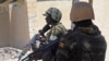 FILE - Ugandan soldiers patrol a street in the southern town of Merka, 90 km north of Somalia's capital Mogadishu, July 17, 2016, as part of the African Union Mission in Somalia (AMISOM).